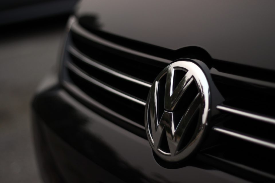 Volkswagen emblem on grill of black European car.