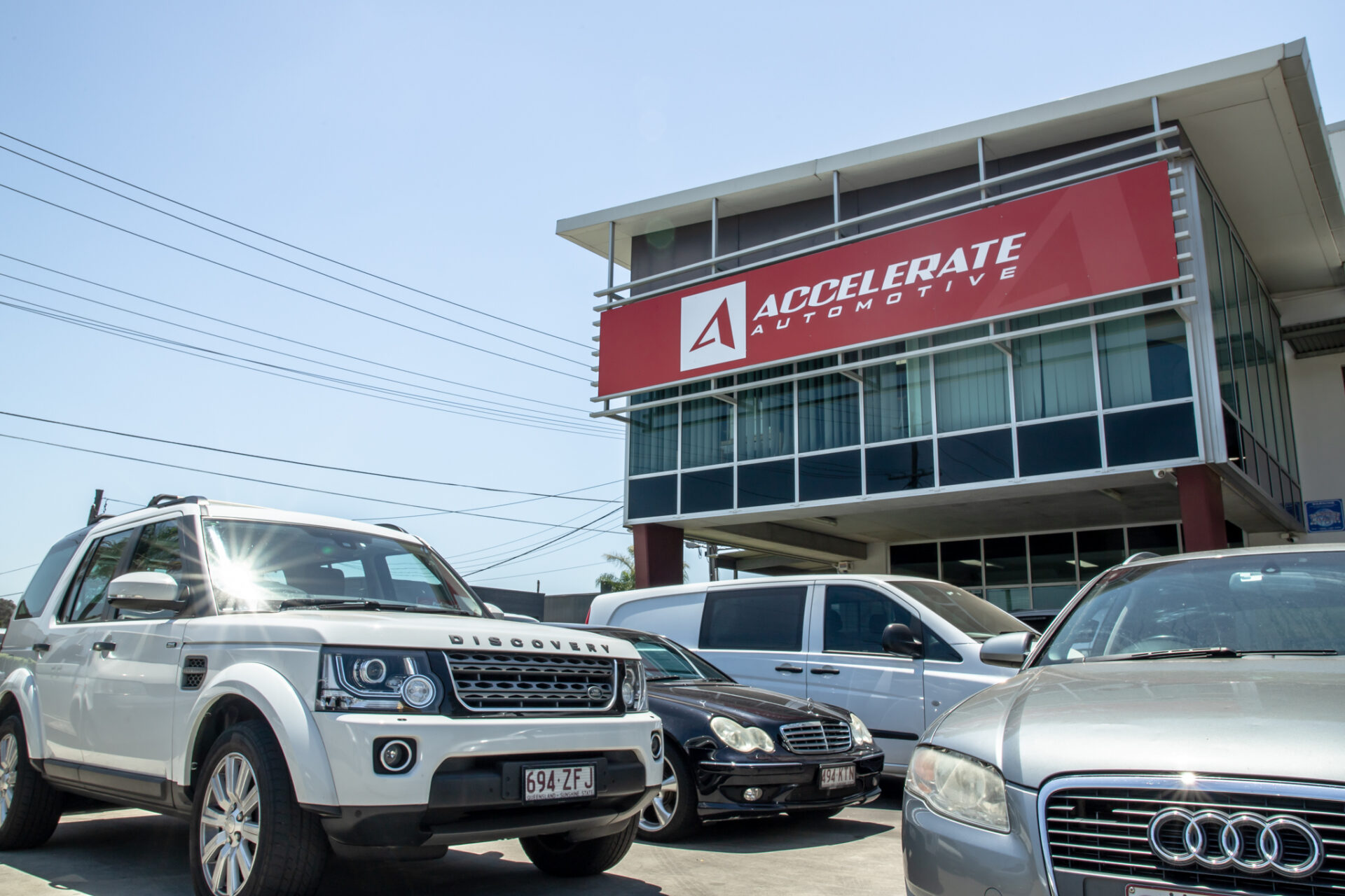 Accelerate Automotive workshop in Brisbane with Audi and European vehicles parked outside.
